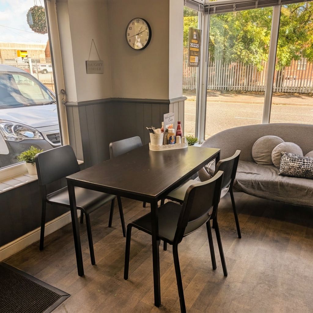 Table and chairs by the window inside Wayfarer Cafe on Osmaston Road, Derby